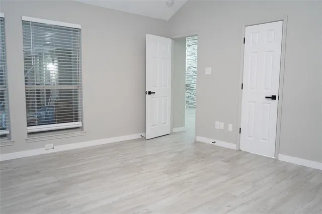 a large kitchen with a sink a refrigerator and chandelier