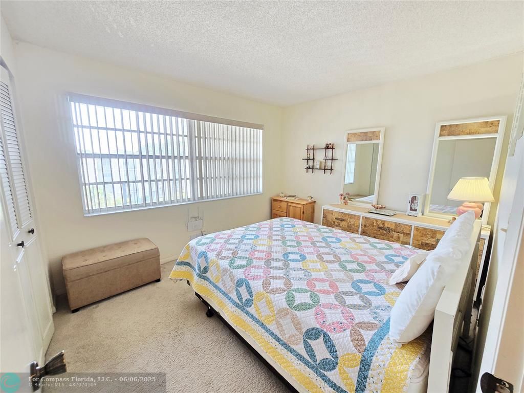 3000 Northwest 48th Terrace, Unit 430 Lauderdale Lakes, FL 33313 - Photo 7 of 15 a bedroom with a bed window and a dresser
