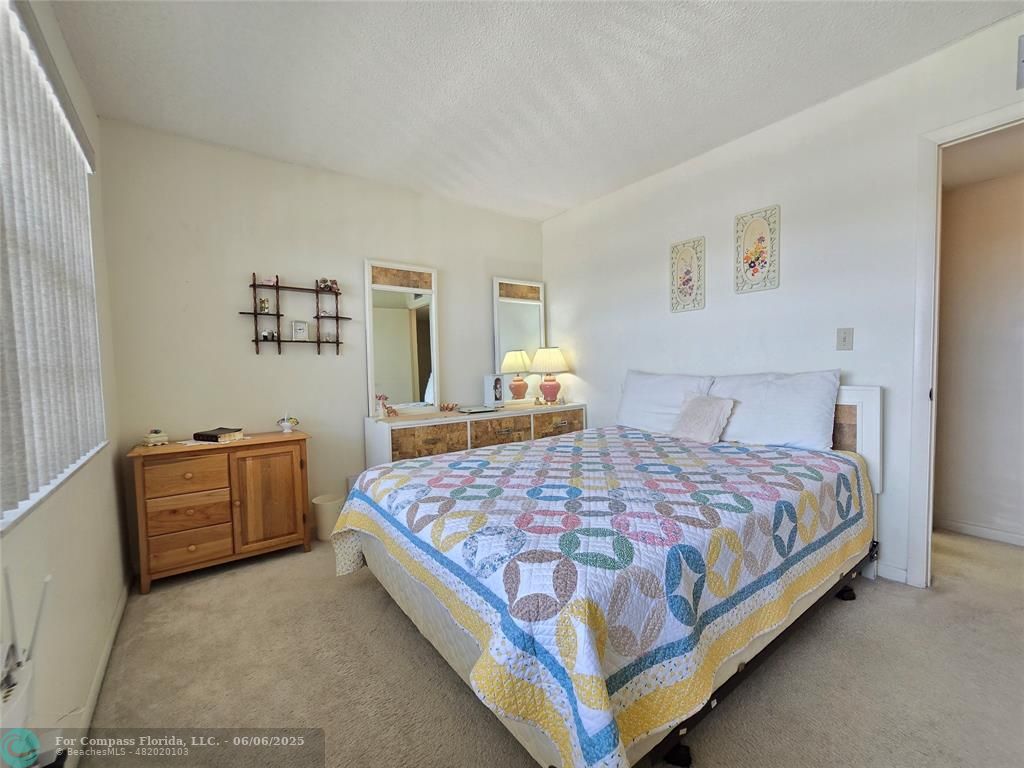 3000 Northwest 48th Terrace, Unit 430 Lauderdale Lakes, FL 33313 - Photo 8 of 15 a bedroom with a bed and dresser