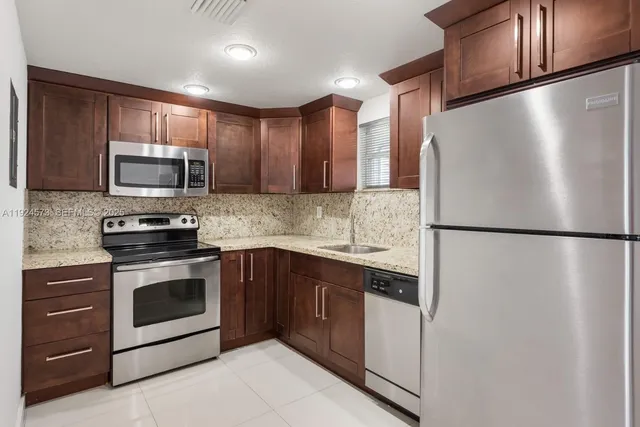 a kitchen with a refrigerator sink and microwave