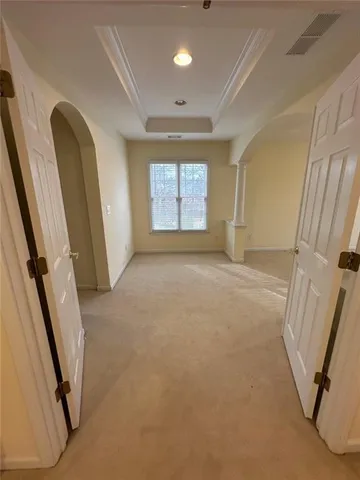 an empty room with windows and stairs