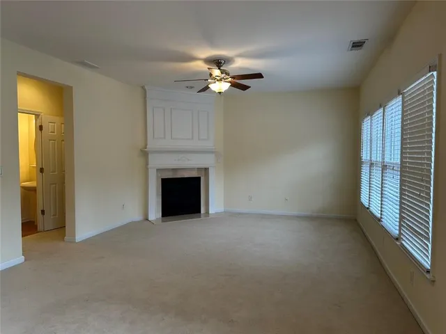 a view of a livingroom with a ceiling fan lamp and a fireplace