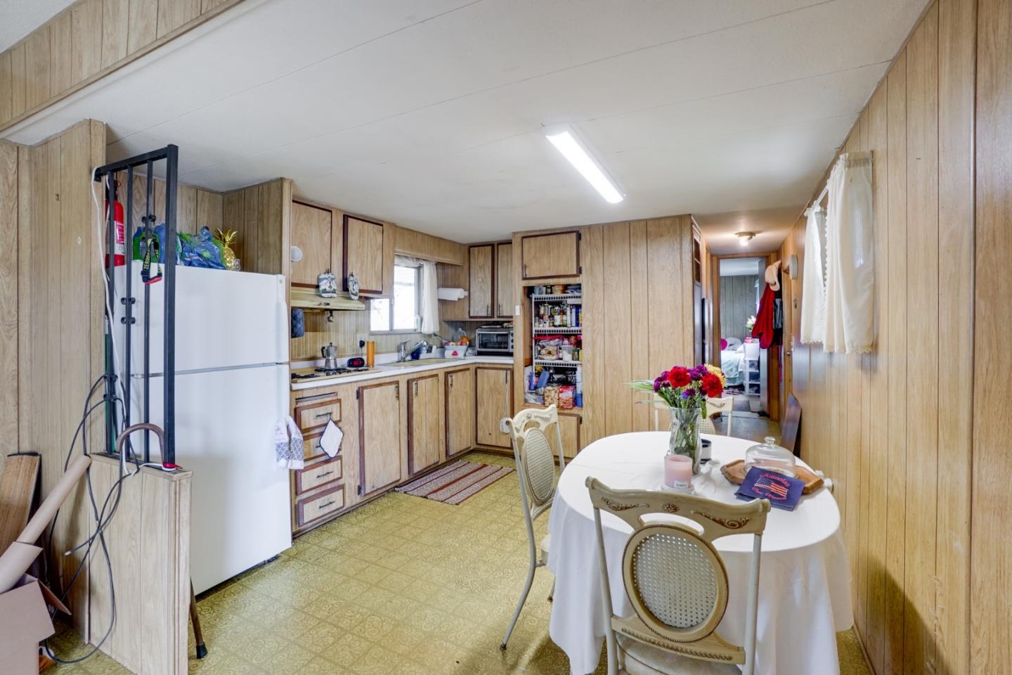 2 Sea Shell Circle, Unit 2 Half Moon Bay, CA 94019 - Photo 11 of 28 a kitchen with a refrigerator sink and cabinets