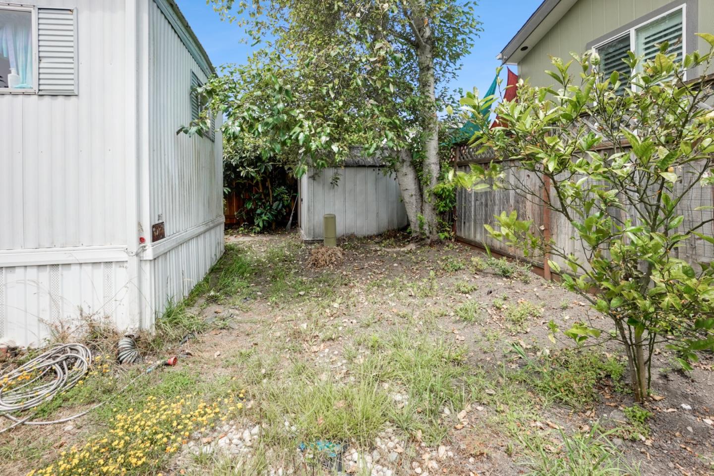 2 Sea Shell Circle, Unit 2 Half Moon Bay, CA 94019 - Photo 18 of 28 a view of a house with a tree and wooden fence