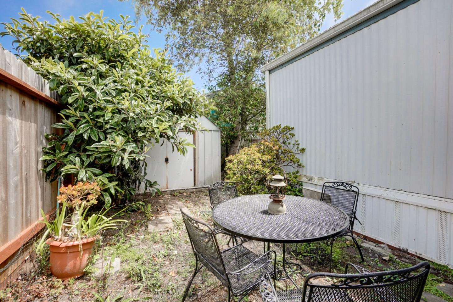 2 Sea Shell Circle, Unit 2 Half Moon Bay, CA 94019 - Photo 19 of 28 a view of a backyard with table and chairs and potted plants