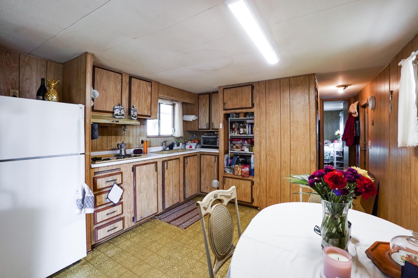 2 Sea Shell Circle, Unit 2 Half Moon Bay, CA 94019 - Photo 3 of 28 a kitchen with stainless steel appliances kitchen island granite countertop a refrigerator a stove a sink dishwasher and white cabinets with wooden floor