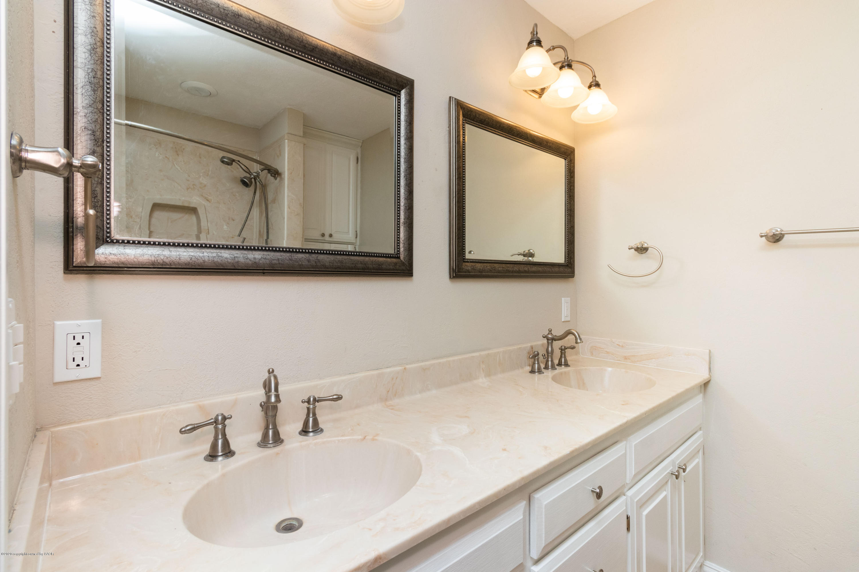 6605 Dreyfuss Road Amarillo, TX 79106 - Photo 19 of 39 a bathroom with a sink and two mirror