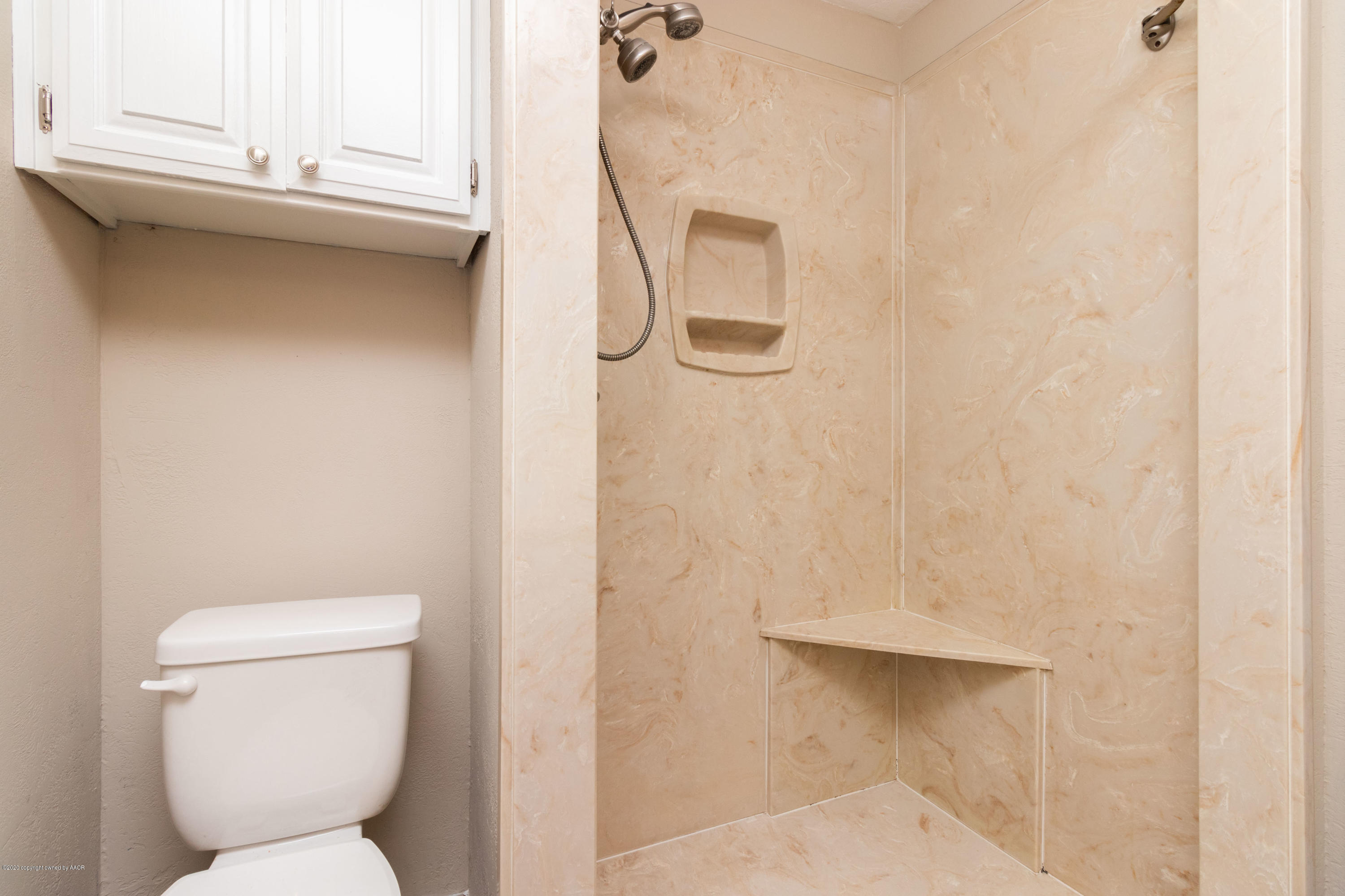 6605 Dreyfuss Road Amarillo, TX 79106 - Photo 20 of 39 a bathroom with a toilet and a shower