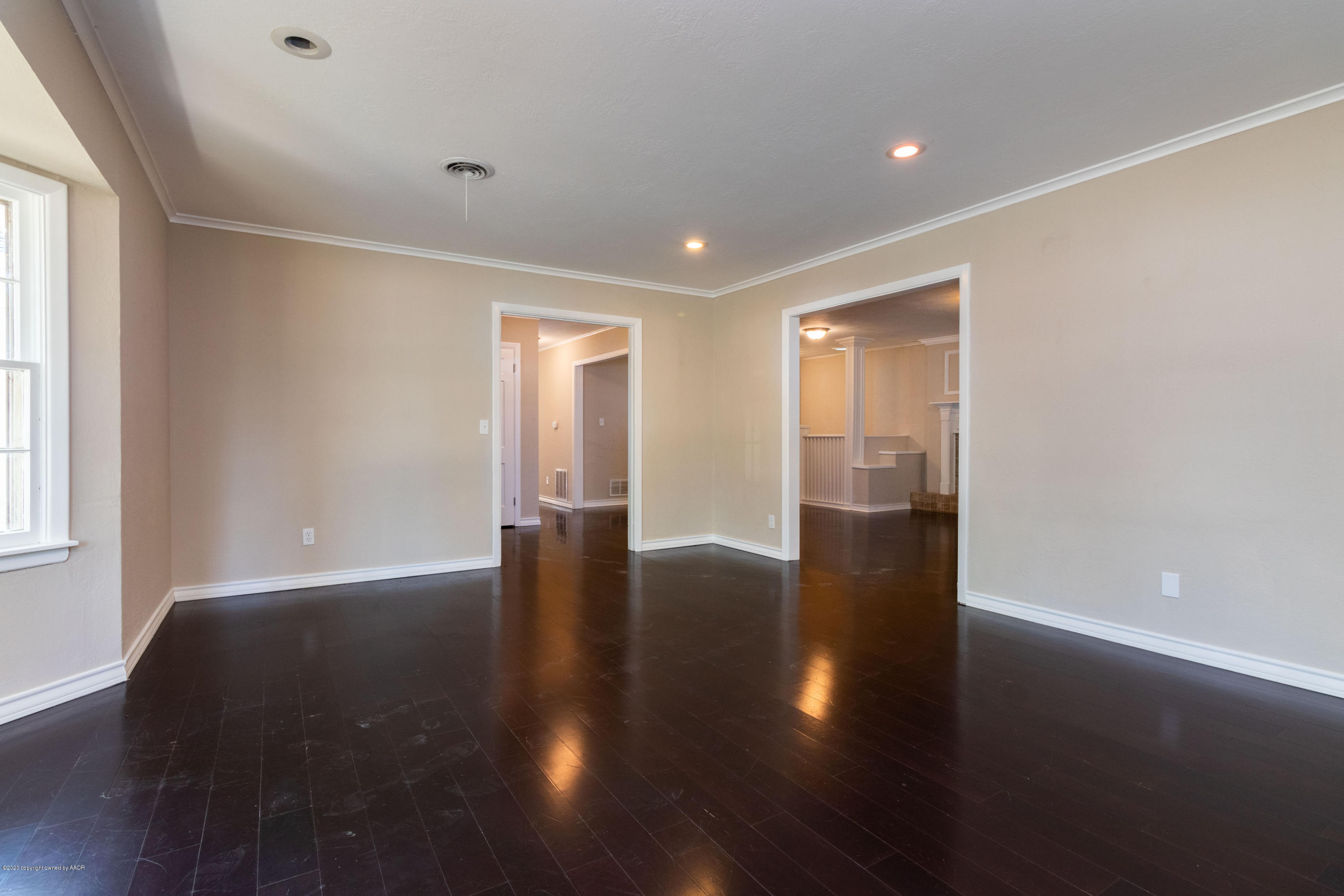 6605 Dreyfuss Road Amarillo, TX 79106 - Photo 5 of 39 a view of an empty room with wooden floor and a window