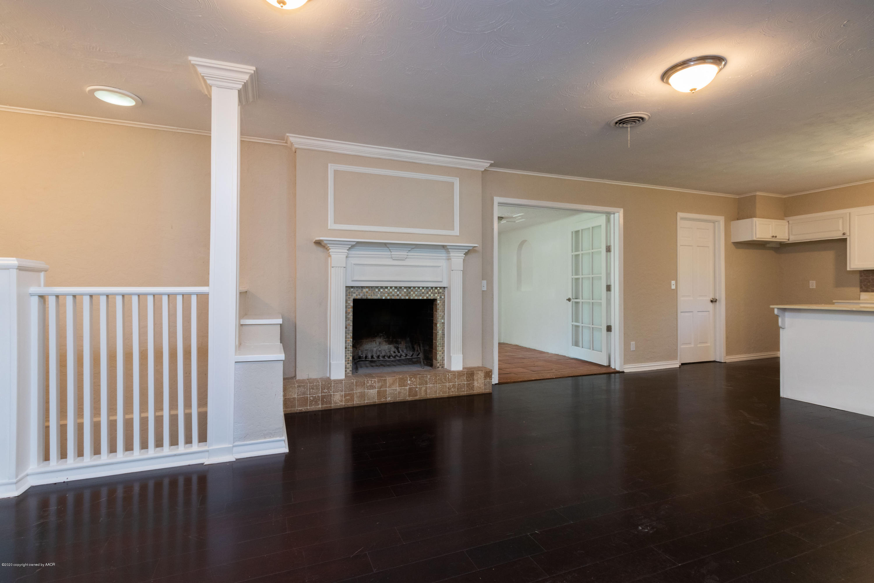 6605 Dreyfuss Road Amarillo, TX 79106 - Photo 6 of 39 a view of a livingroom with wooden floor a fireplace and window