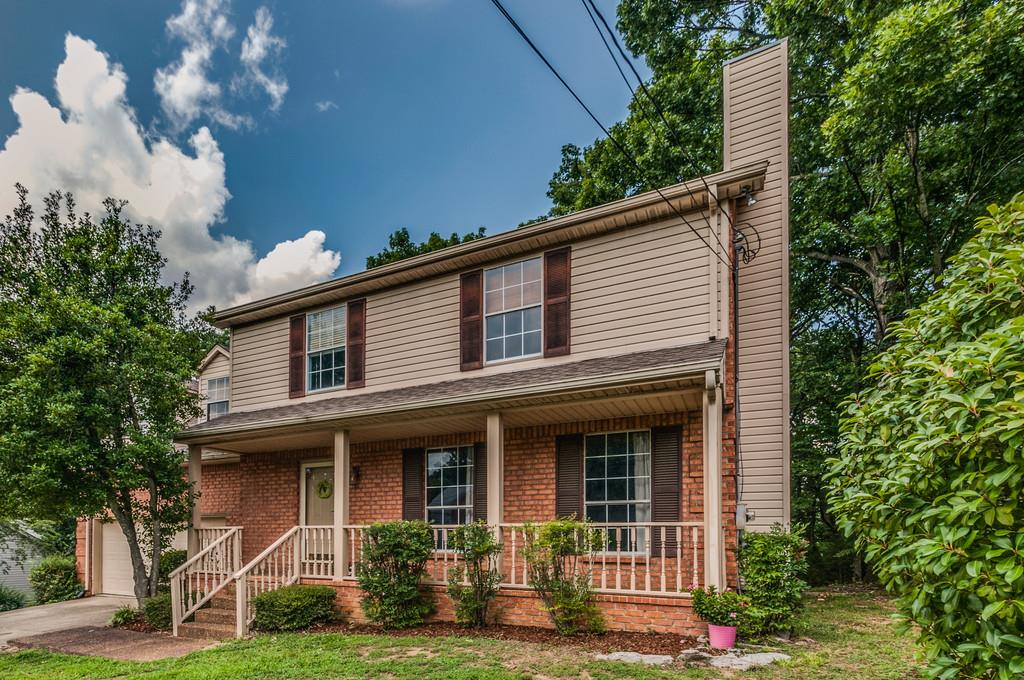 2326 Rader Ridge Road Antioch, TN 37013 - Photo 2 of 29 a front view of a house with a yard and potted plants