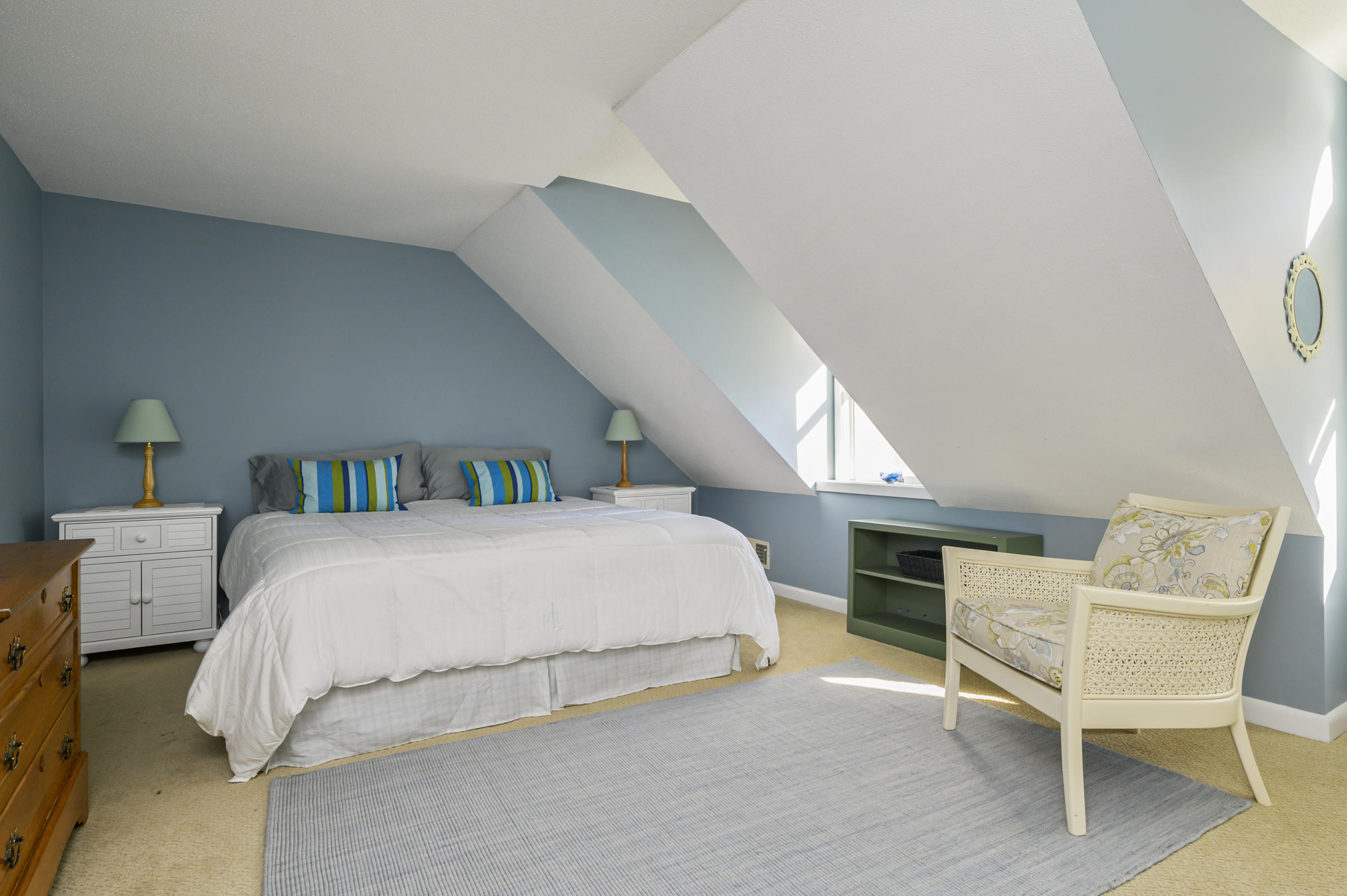 Undisclosed Address Mashpee, MA 02649 - Photo 15 of 21 a spacious bedroom with a bed and a chair