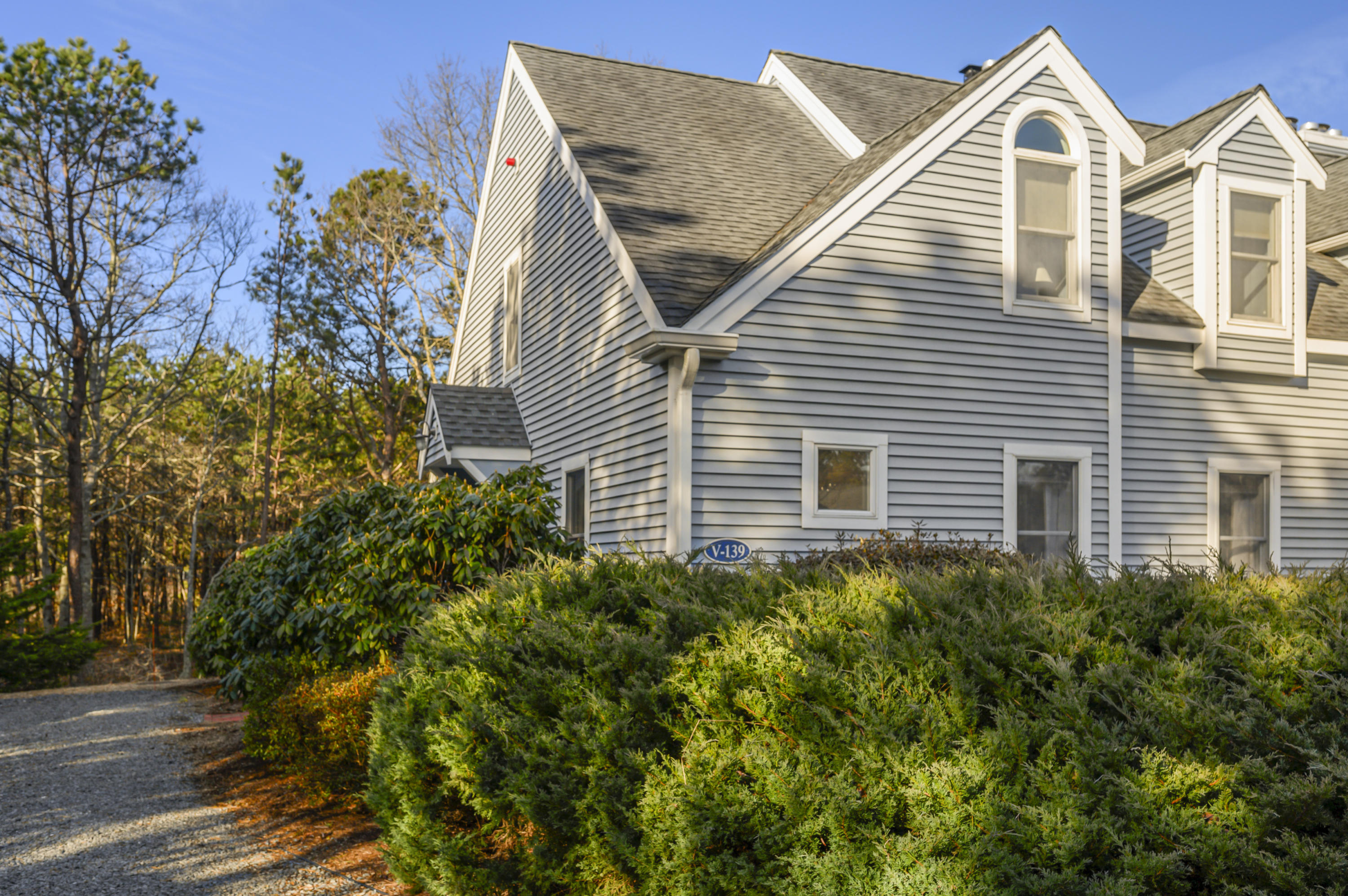 Undisclosed Address Mashpee, MA 02649 - Photo 3 of 21 a view of a house with a yard and potted plants