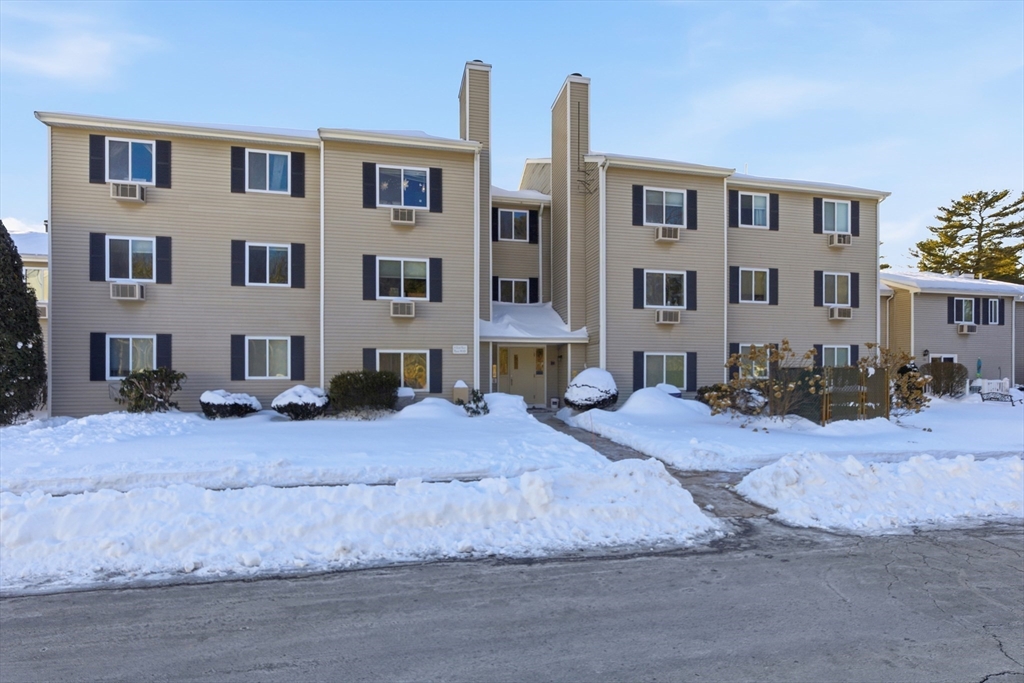 4 Erick Road, Unit 90 Mansfield, MA 02048 - Photo 25 of 30 a front view of a building with a yard