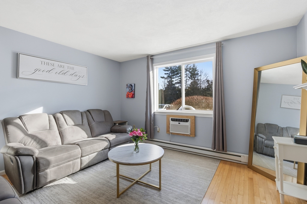 4 Erick Road, Unit 90 Mansfield, MA 02048 - Photo 5 of 30 a living room with furniture and a wooden floor