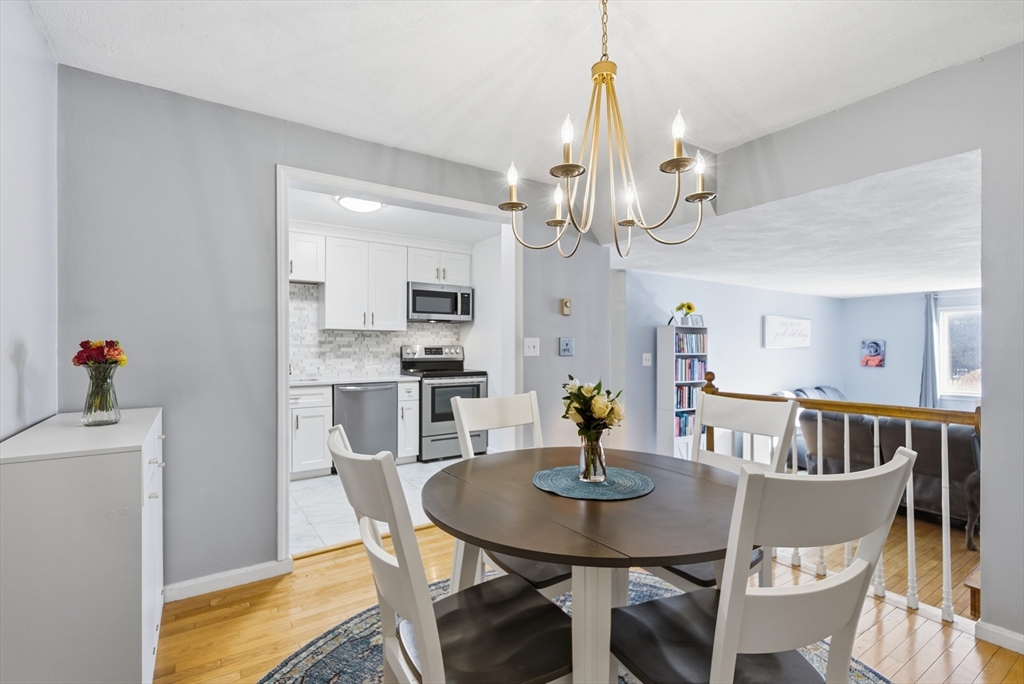 4 Erick Road, Unit 90 Mansfield, MA 02048 - Photo 8 of 30 a view of a dining room with furniture and wooden floor
