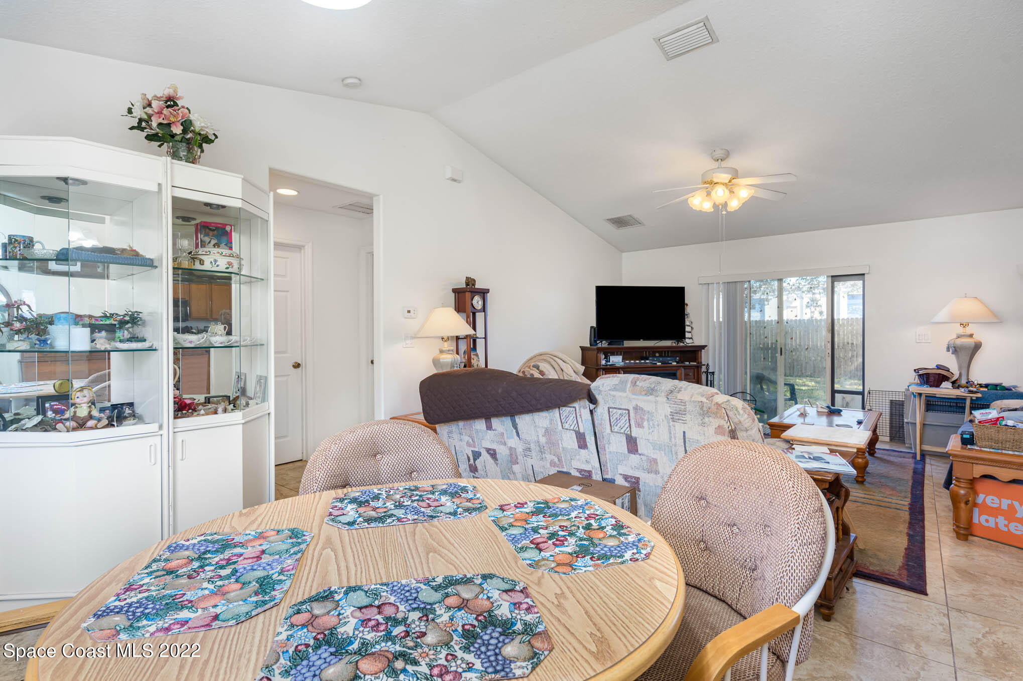 1247 Van Tassel Trail Palm Bay, FL 32905 - Photo 13 of 31 a bedroom with furniture a flat screen tv and a chandelier