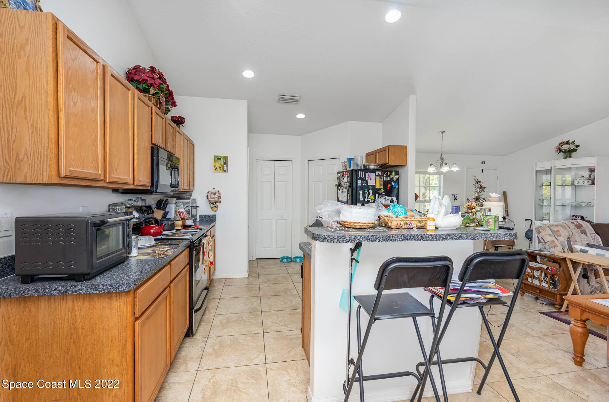 1247 Van Tassel Trail Palm Bay, FL 32905 - Photo 16 of 31 a kitchen view of a dining table chairs and utility room