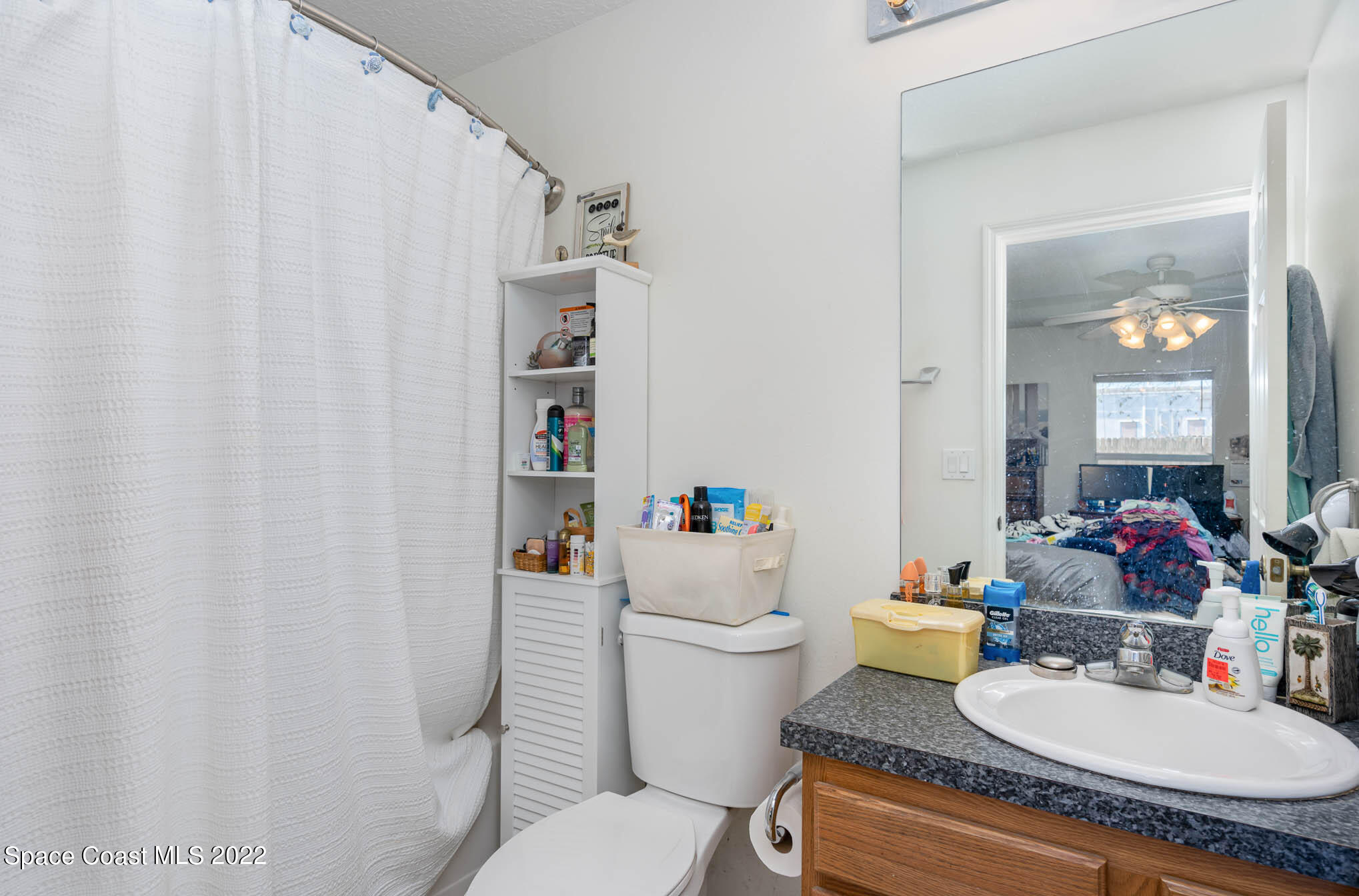 1247 Van Tassel Trail Palm Bay, FL 32905 - Photo 17 of 31 a white toilet sitting next to a bathroom sink
