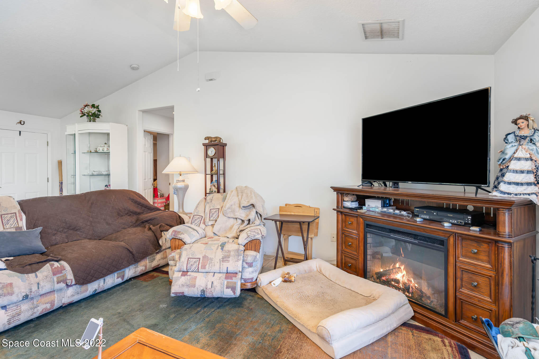 1247 Van Tassel Trail Palm Bay, FL 32905 - Photo 2 of 31 a living room with furniture and a flat screen tv
