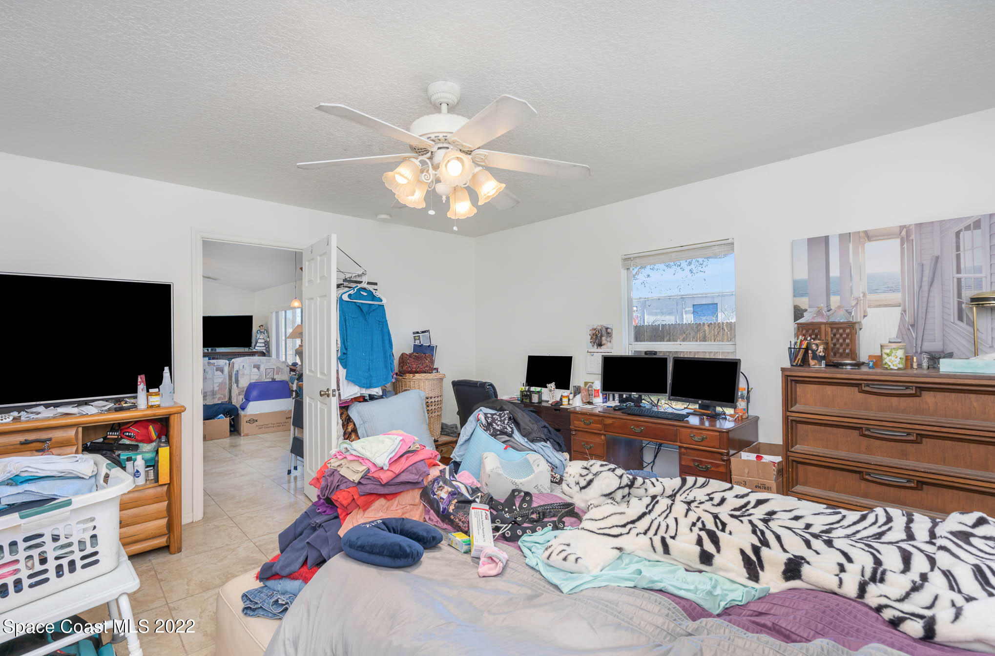 1247 Van Tassel Trail Palm Bay, FL 32905 - Photo 22 of 31 a living room with furniture and a flat screen tv