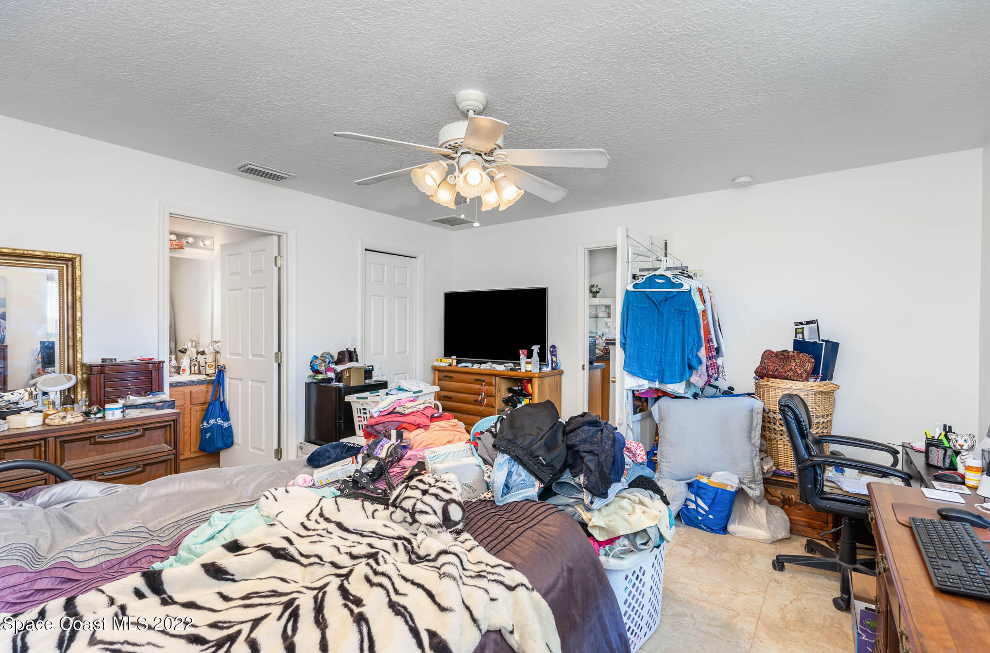 1247 Van Tassel Trail Palm Bay, FL 32905 - Photo 23 of 31 a bed room with a bed and a flat screen tv