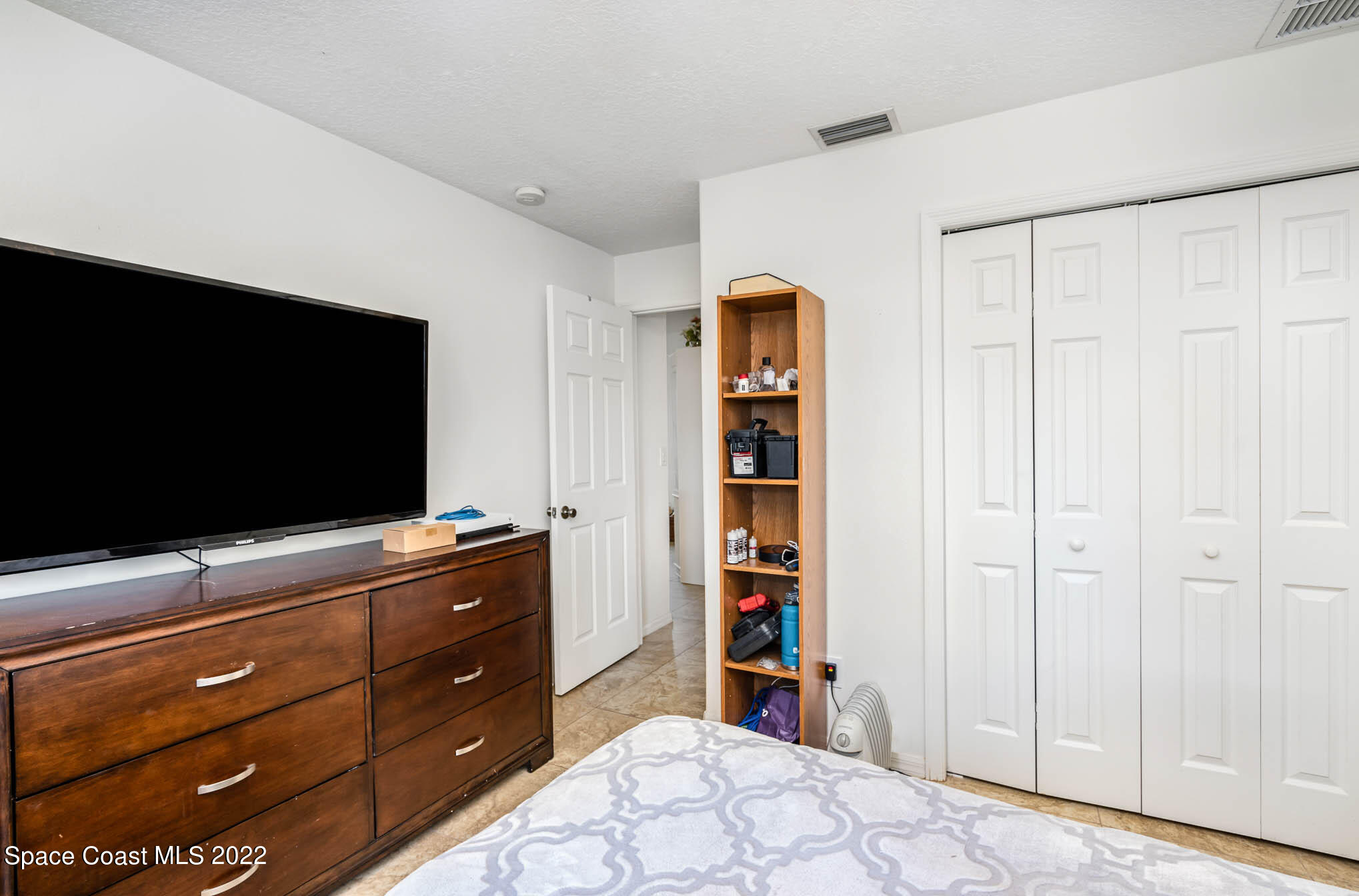 1247 Van Tassel Trail Palm Bay, FL 32905 - Photo 24 of 31 a bedroom with a bed and a flat screen tv
