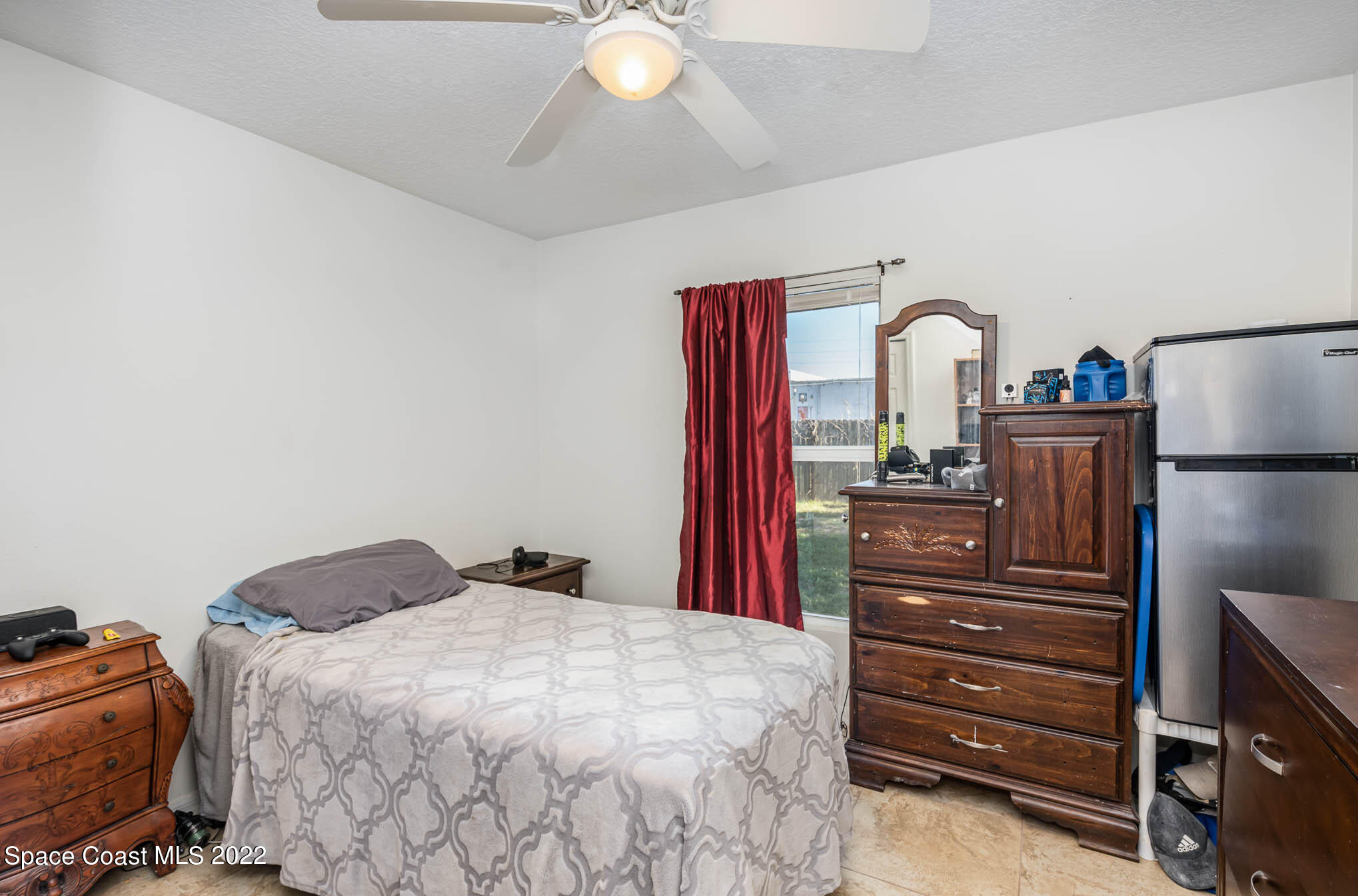 1247 Van Tassel Trail Palm Bay, FL 32905 - Photo 25 of 31 a bedroom with a bed and a dresser