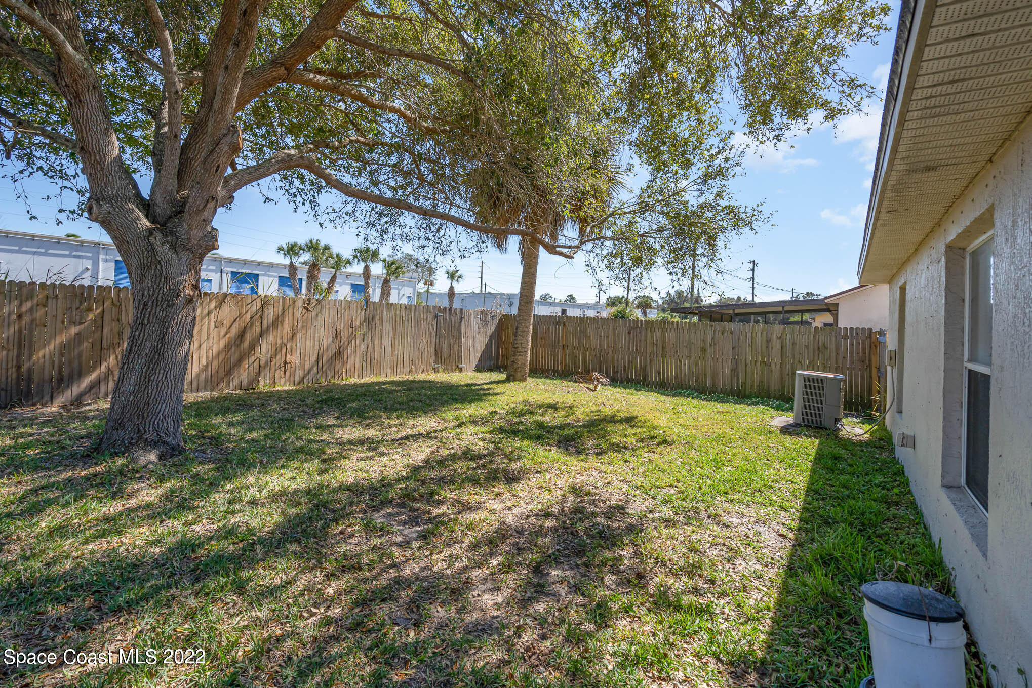1247 Van Tassel Trail Palm Bay, FL 32905 - Photo 27 of 31 a backyard of a house with lots of green space