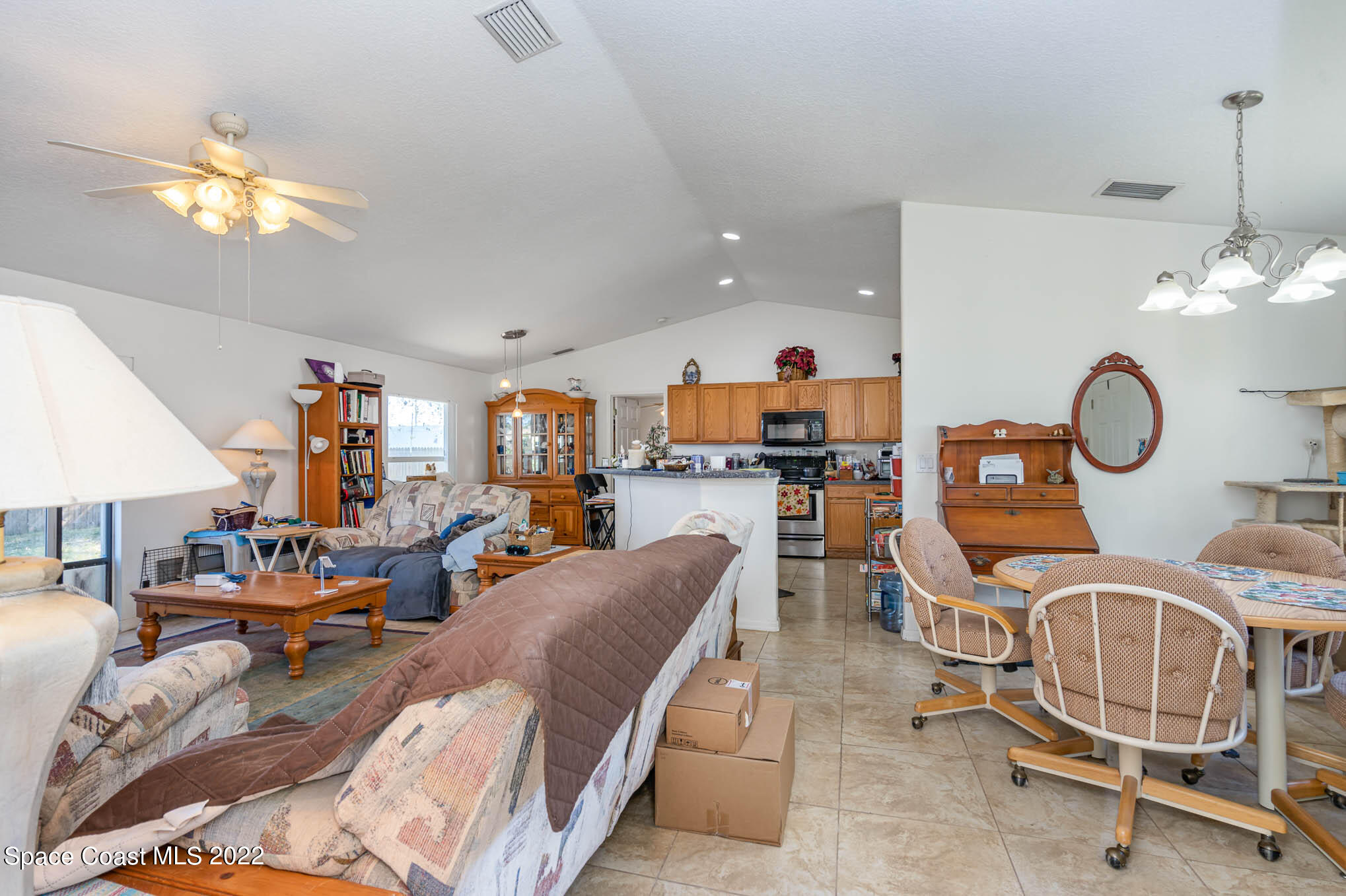 1247 Van Tassel Trail Palm Bay, FL 32905 - Photo 3 of 31 a view of a livingroom with furniture and a chandelier