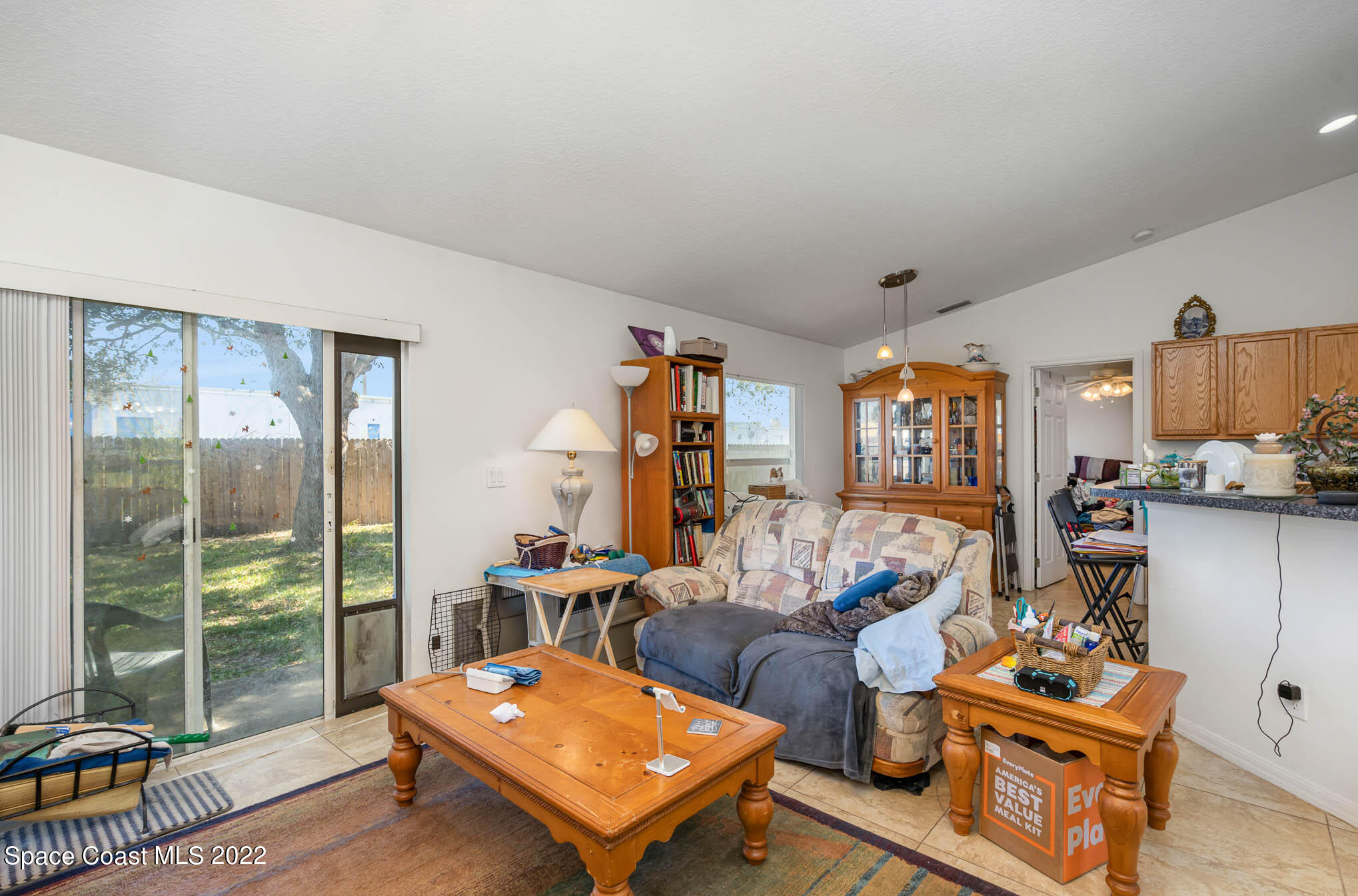 1247 Van Tassel Trail Palm Bay, FL 32905 - Photo 5 of 31 a living room with furniture a rug and a large window