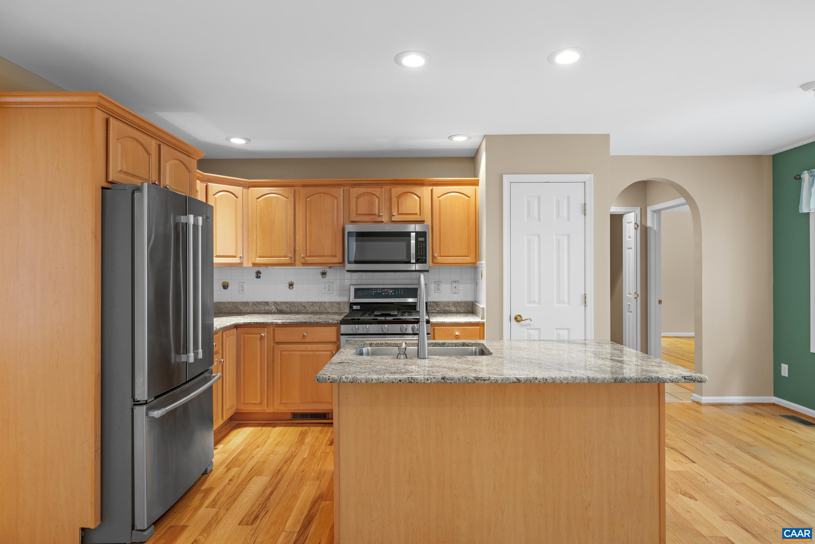 34 Zephyr Road Palmyra, VA 22963 - Photo 22 of 38 a kitchen with kitchen island granite countertop a refrigerator stove top oven and sink