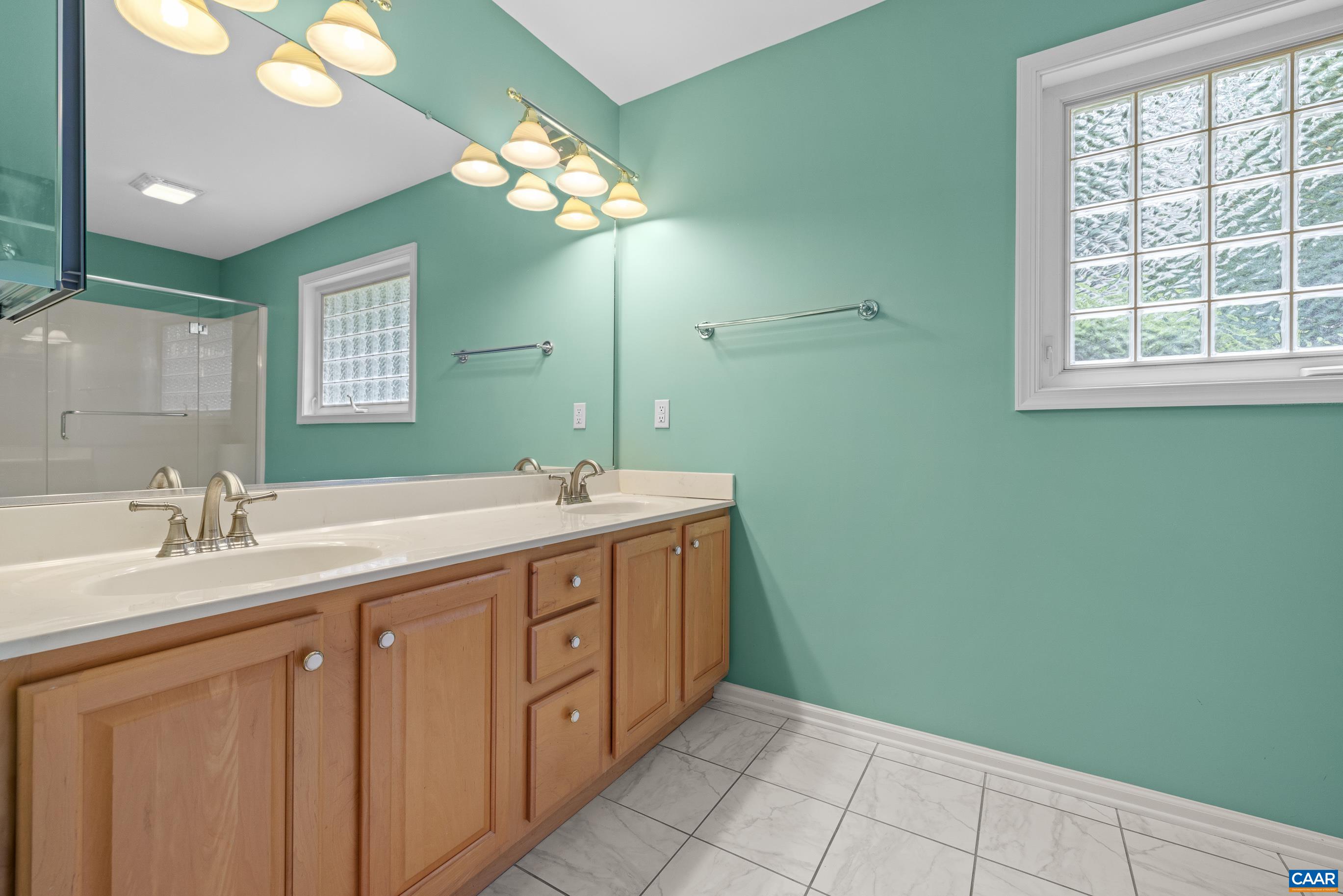 34 Zephyr Road Palmyra, VA 22963 - Photo 31 of 38 a spacious bathroom with a double vanity sink a large mirror and a shower
