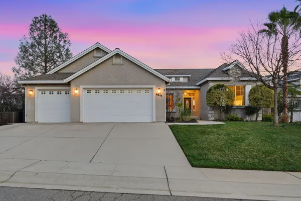 a front view of a house with a yard and garage