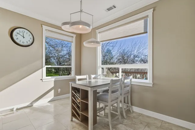 a view of a dining room with furniture window and outside view