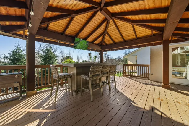 a view of a patio with table and chairs with wooden floor