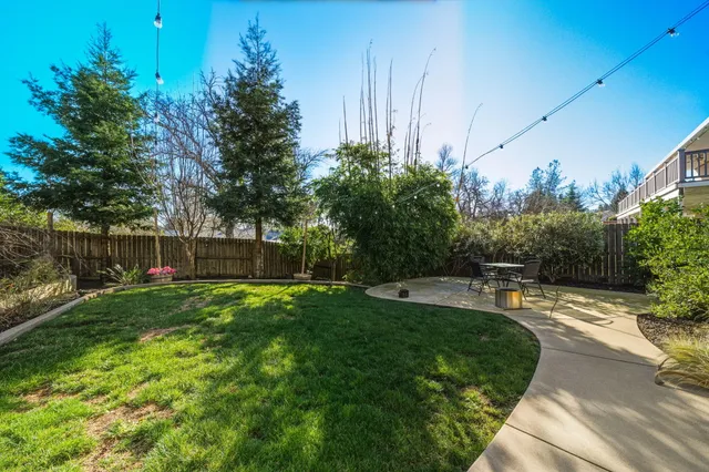 a view of a backyard with sitting area