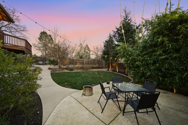 a view of a backyard with sitting area