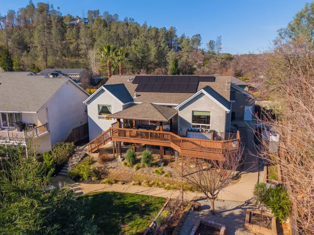 an aerial view of a house with a yard