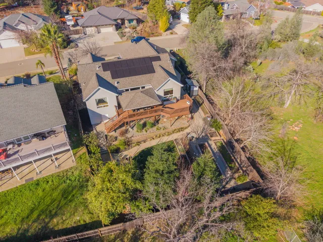 an aerial view of a house with a yard and parking
