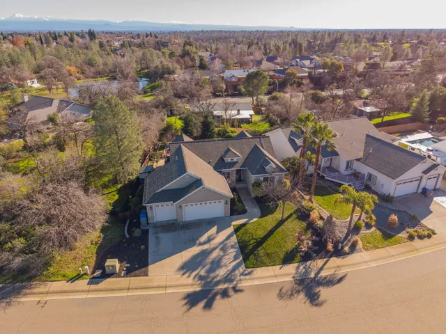 an aerial view of a house with a swimming pool