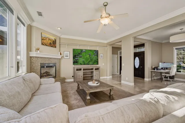 a living room with furniture a fireplace and a flat screen tv