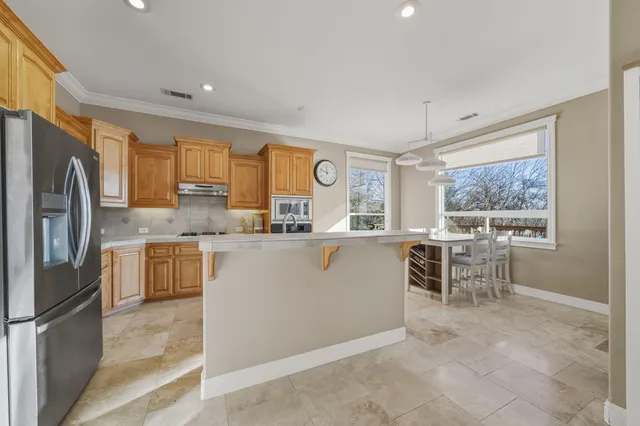 a kitchen with refrigerator and window