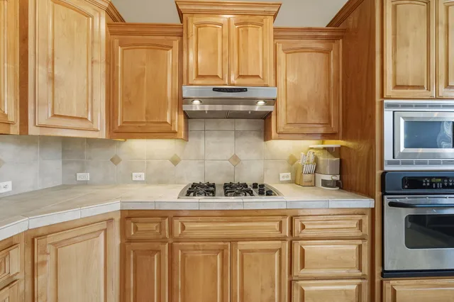 a kitchen with a stove and a cabinets