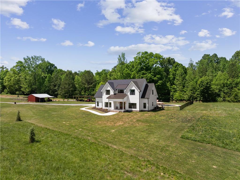 876 Cline Road Resaca, GA 30735 - Photo 2 of 57 a front view of a house with a garden and trees