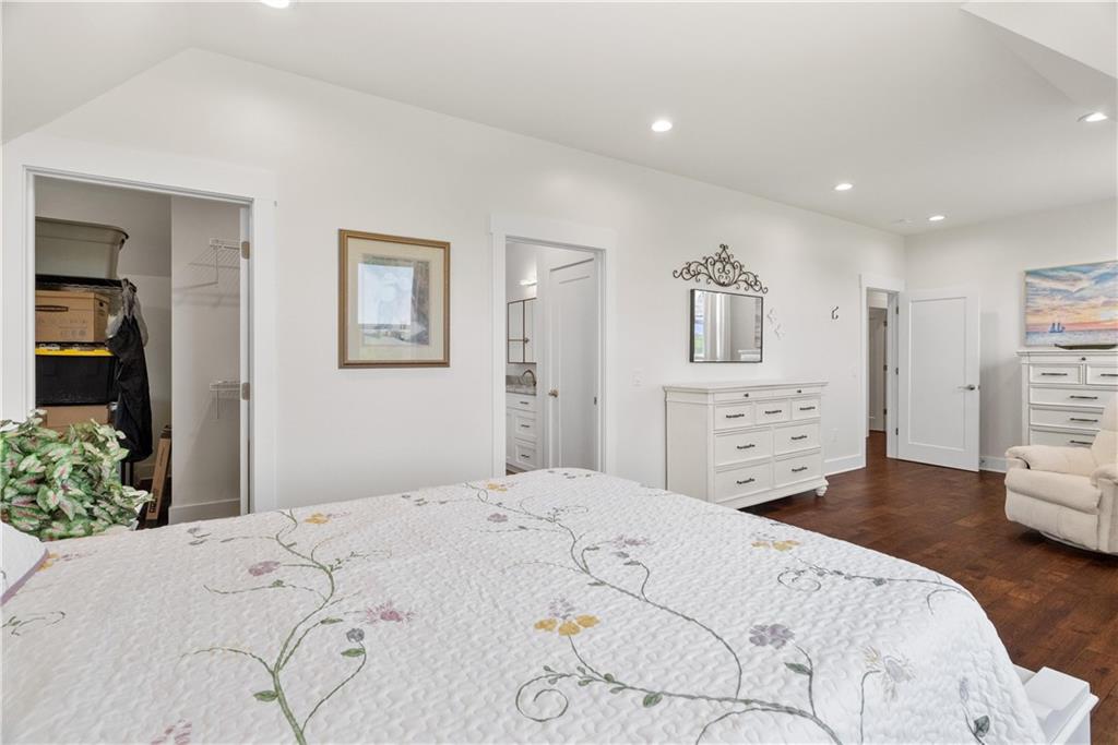 876 Cline Road Resaca, GA 30735 - Photo 31 of 57 a bedroom with a large bed and a chandelier