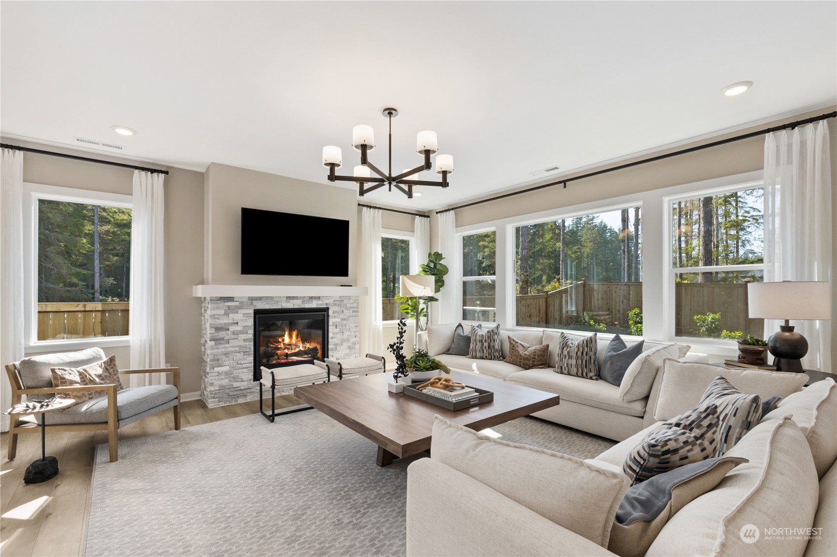 4461 Wandering Way, Unit 58 Port Orchard, WA 98367 - Photo 7 of 26 a living room with furniture a fireplace and a flat screen tv