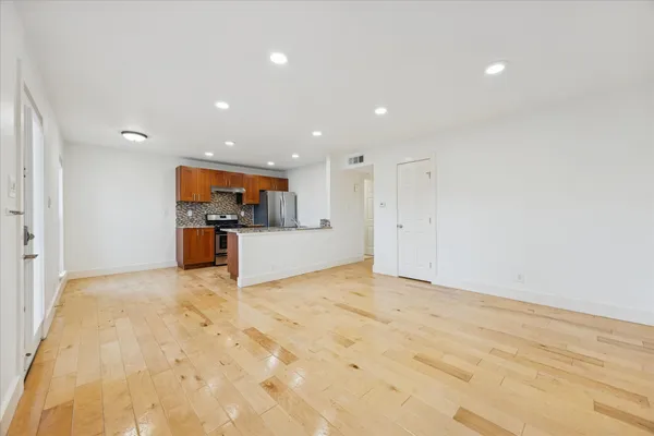 a kitchen with stainless steel appliances granite countertop a stove a sink and a refrigerator