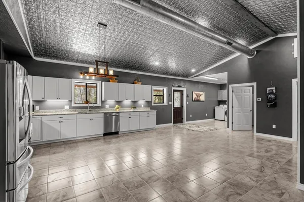 a large kitchen with cabinets and stainless steel appliances