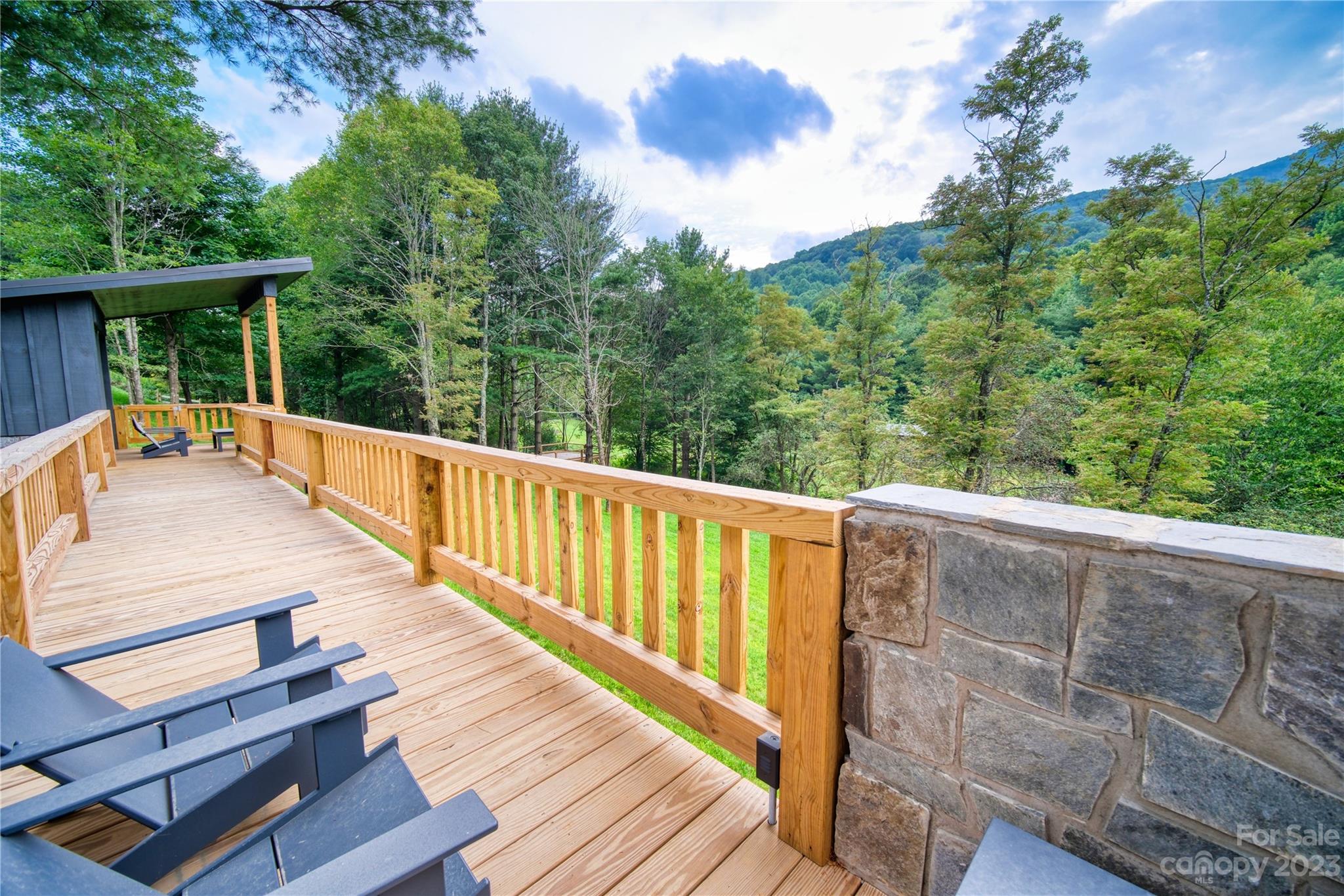 3765 Bald Mountain Road, Unit 2 West Jefferson, NC 28694 - Photo 12 of 35 a view of deck with two chairs and wooden floor